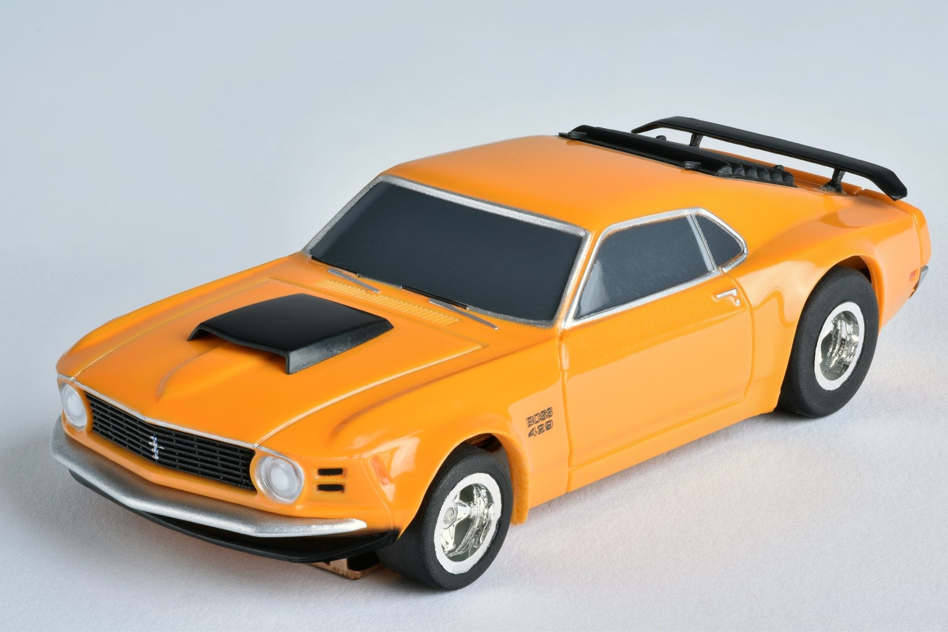 AFX Racing Ford Mustang Boss 429 slot car in orange – front view showing hood scoop and Mustang grille