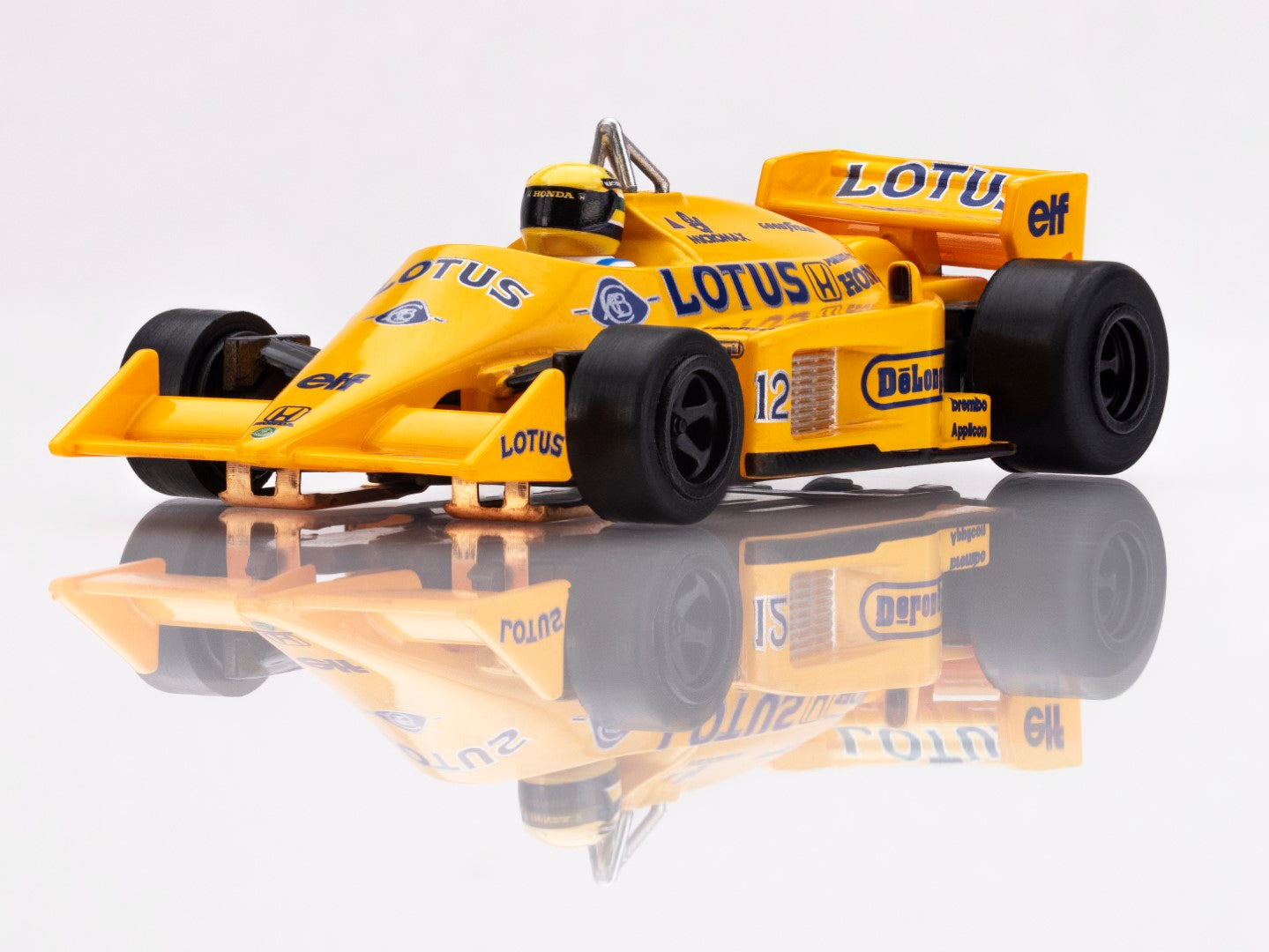 Front view of the yellow AFX Lotus 99T Formula One slot car showing the low profile aerodynamic nose.