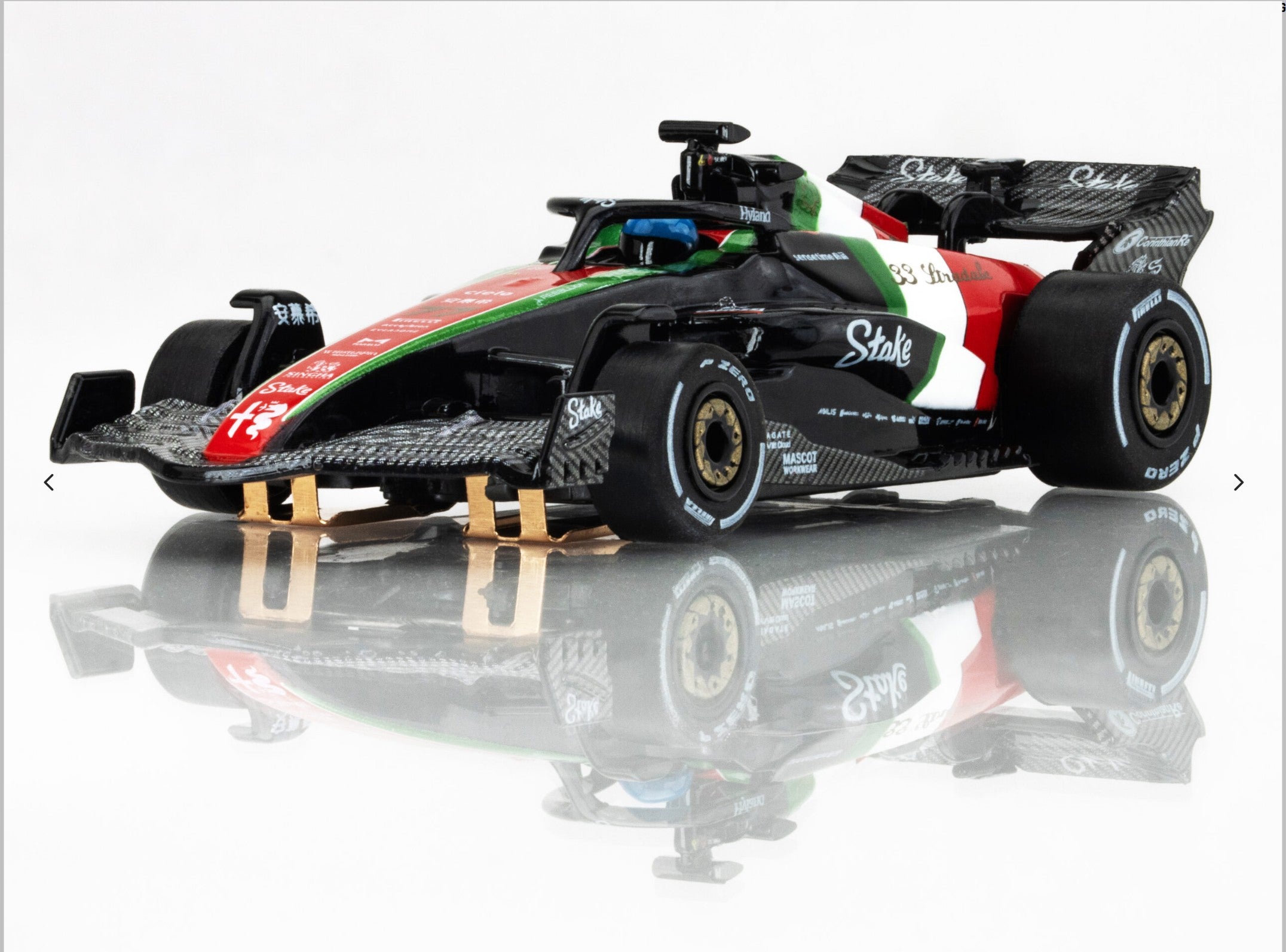 Front-left angle view of AFX 2023 Alfa Romeo F1 Monza car showing gold wheels and aero detailing.