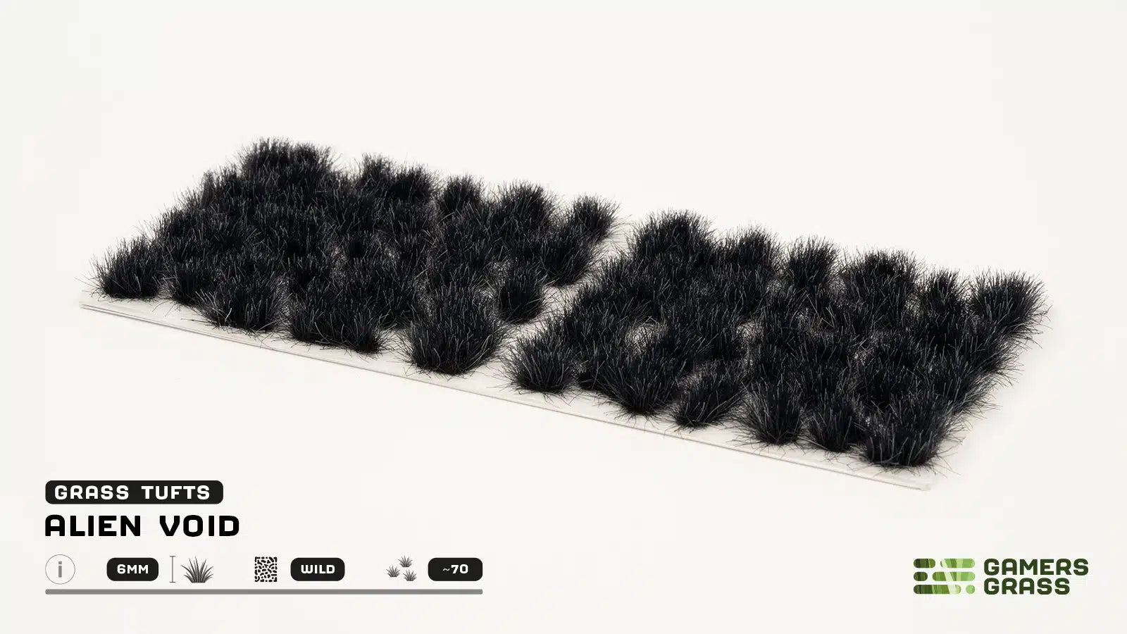 A full sheet of approximately 70 GamersGrass Alien Void black tufts in varying sizes for scale dioramas.