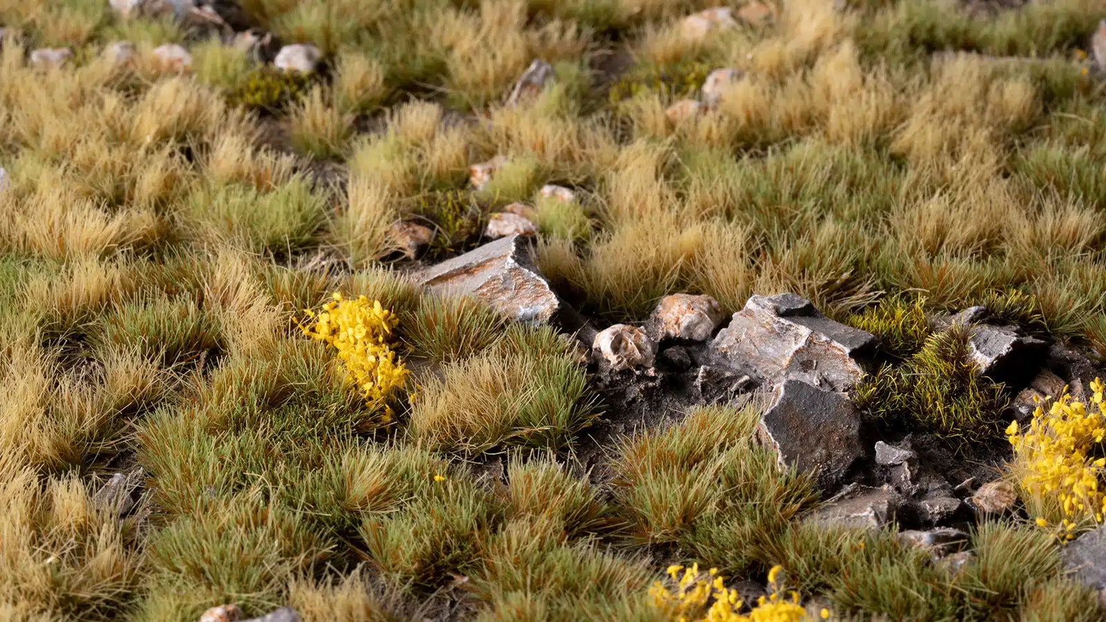 A detailed shot of the GamersGrass Highland Tuft Set showing Yellow Flowers and mixed green vegetation on a professional base.