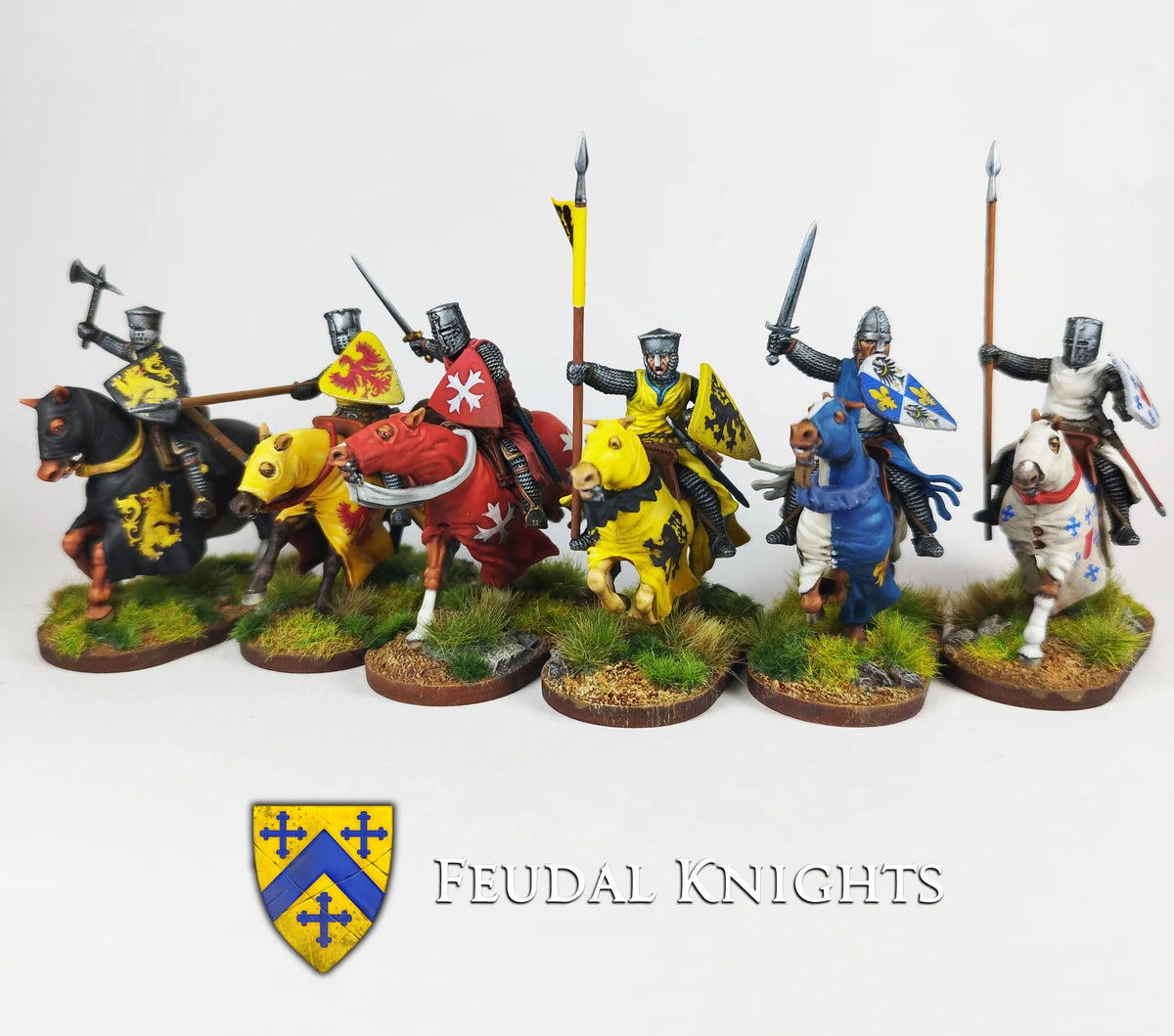 Battle line of six painted Victrix 28mm feudal knights in colorful heraldic barding with lances and swords