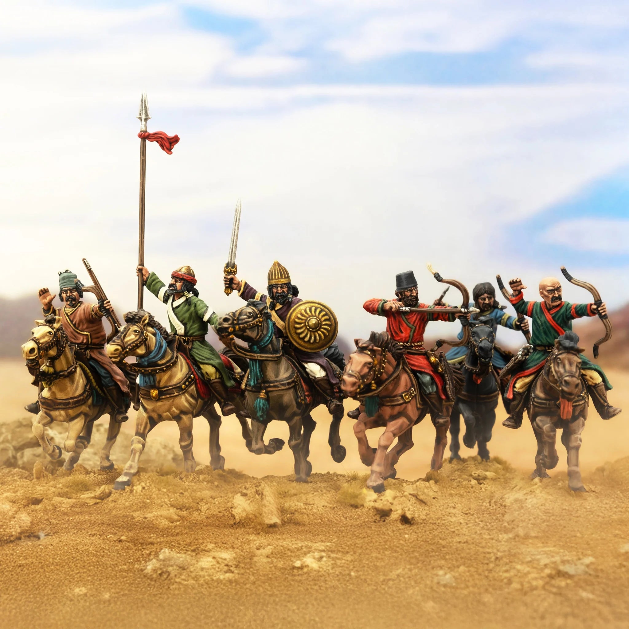 Six painted Victrix Ltd 28mm Islamic Horse Archers advancing in a desert diorama line