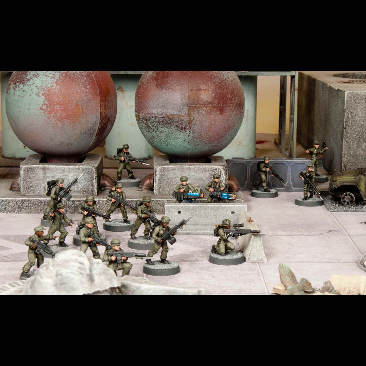 Full squad of painted female infantry deployed in an industrial urban combat battlefield scene