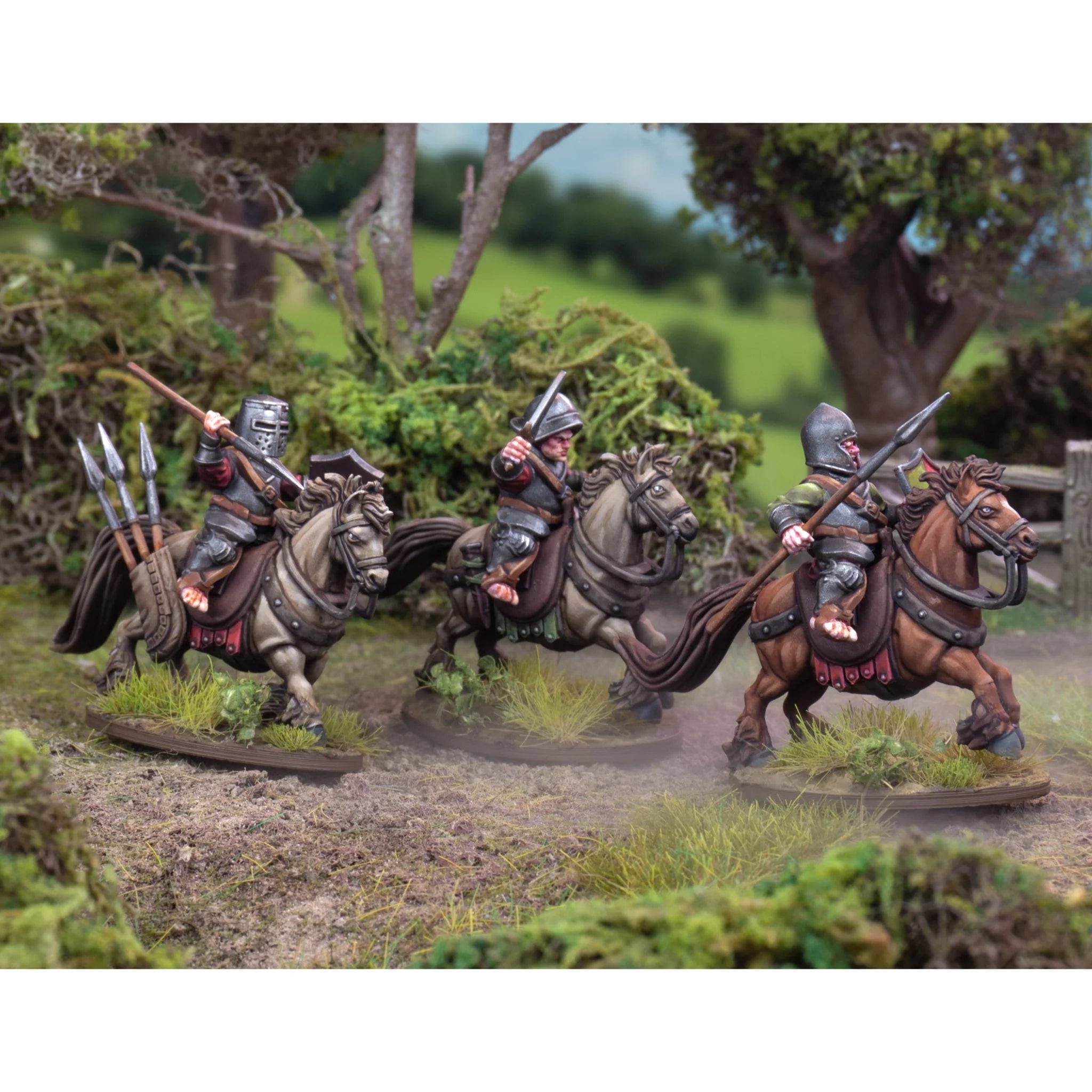 Three painted halfling knights riding at the charge along a dirt path