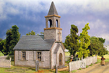 Fully assembled and painted Renedra 28mm American Church surrounded by white picket fencing and miniature figures in a rural scenery diorama.