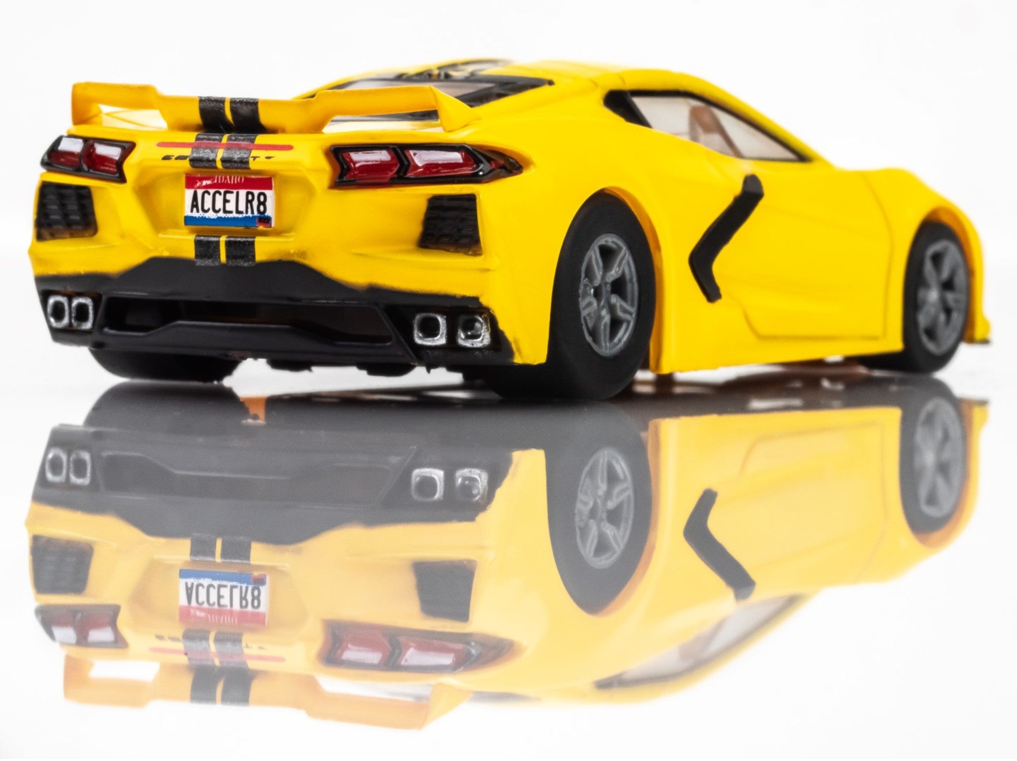 Right Rear view of AFX Corvette C8 slot car in Accelerate Yellow with black trim and hood stripes
