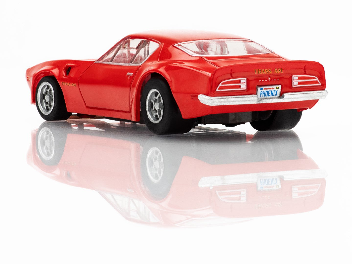 Left Rear profile view of the red AFX 1973 Firebird Trans Am slot car highlighting the Honeycomb wheels and wide body.