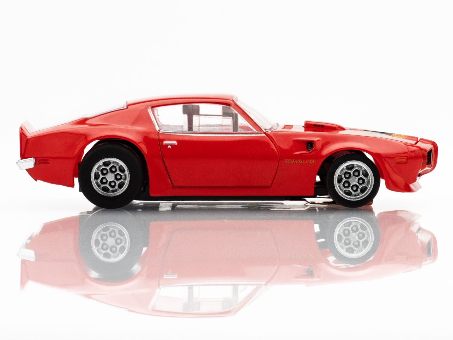 Right Side profile view of the red AFX 1973 Firebird Trans Am slot car highlighting the Honeycomb wheels and wide body.