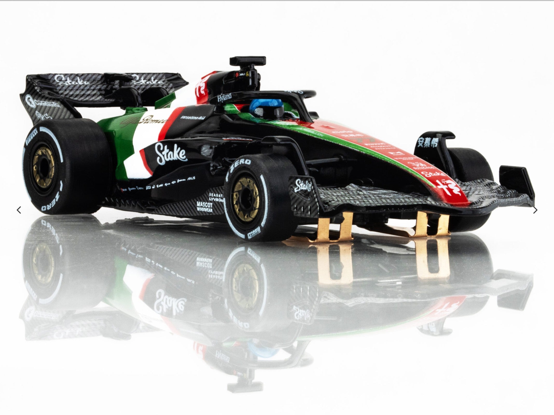Front-right angle view of AFX 2023 Alfa Romeo F1 Monza car showing gold wheels and aero detailing.