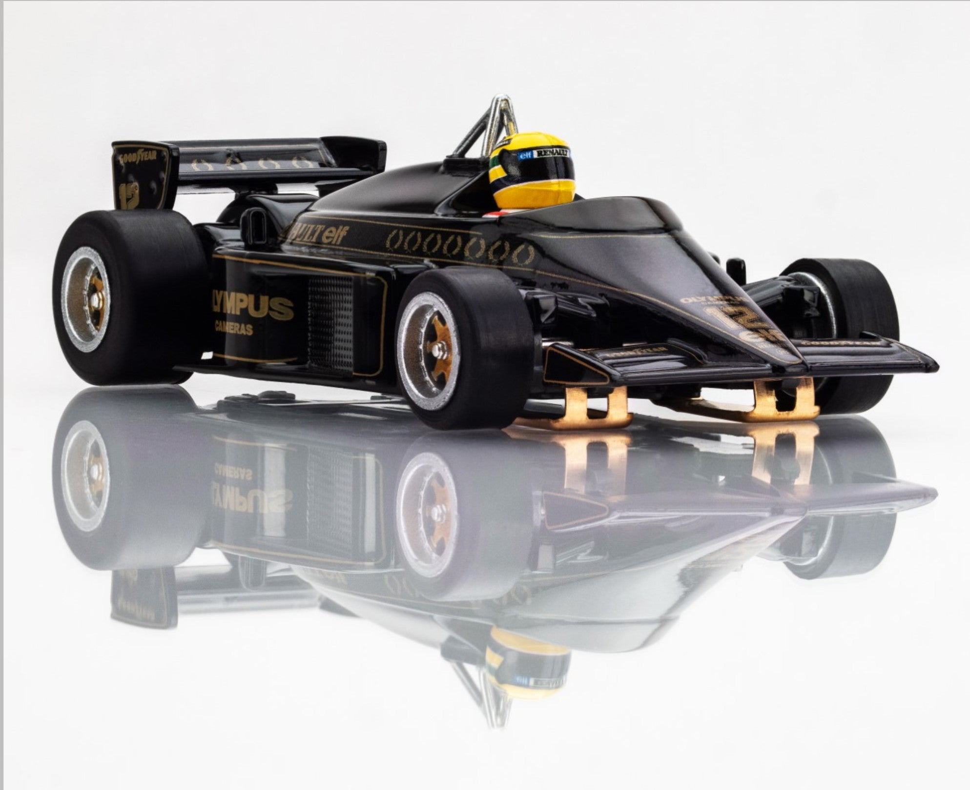Front-right angle of AFX 1985 Lotus 97T HO scale slot car with gold Olympus sponsorship and high-gloss finish.