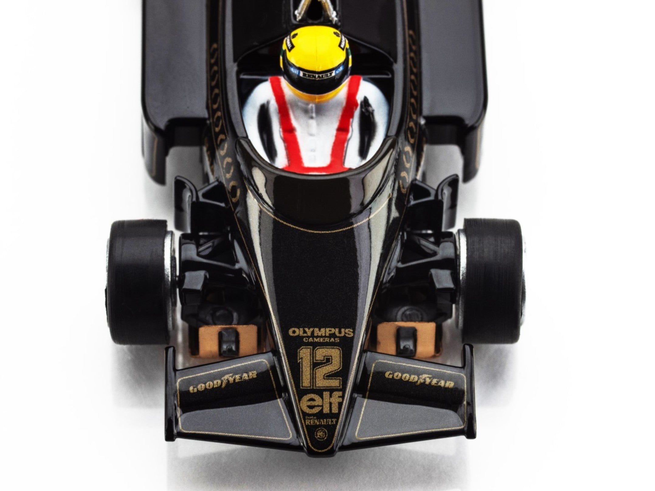 Macro closeup of the AFX Lotus 97T cockpit showing Ayrton Senna’s yellow helmet and gold laurel decals.
