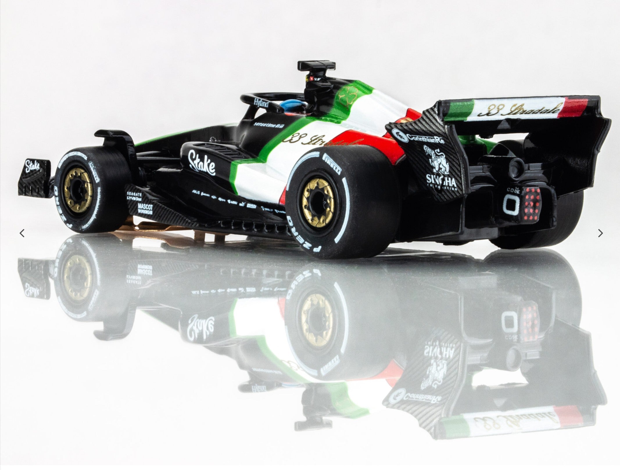 Rear-left angle view of AFX 2023 Alfa Romeo F1 Monza car showing gold wheels and aero detailing.