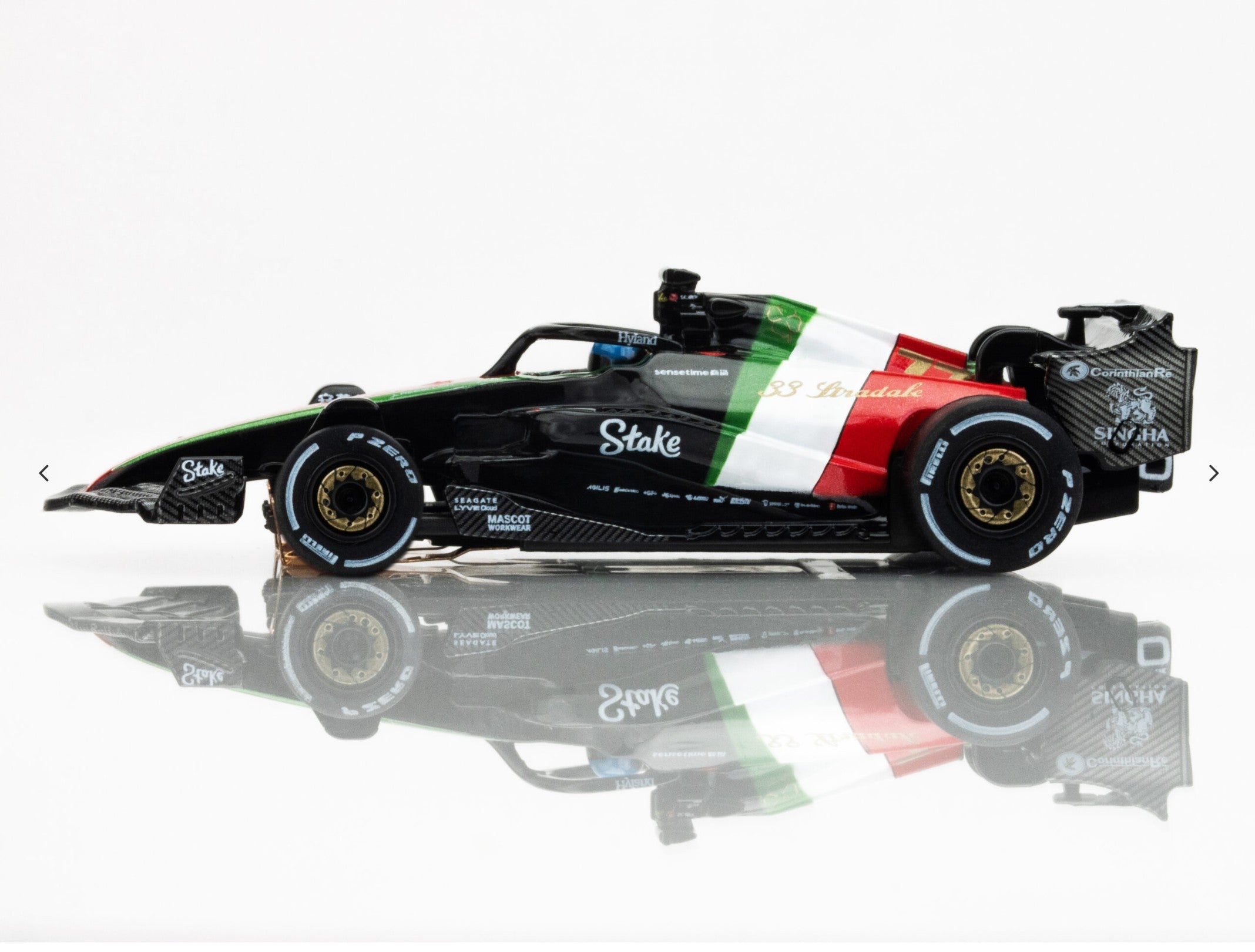 Left side view of AFX 2023 Alfa Romeo F1 Monza car showing gold wheels and aero detailing.