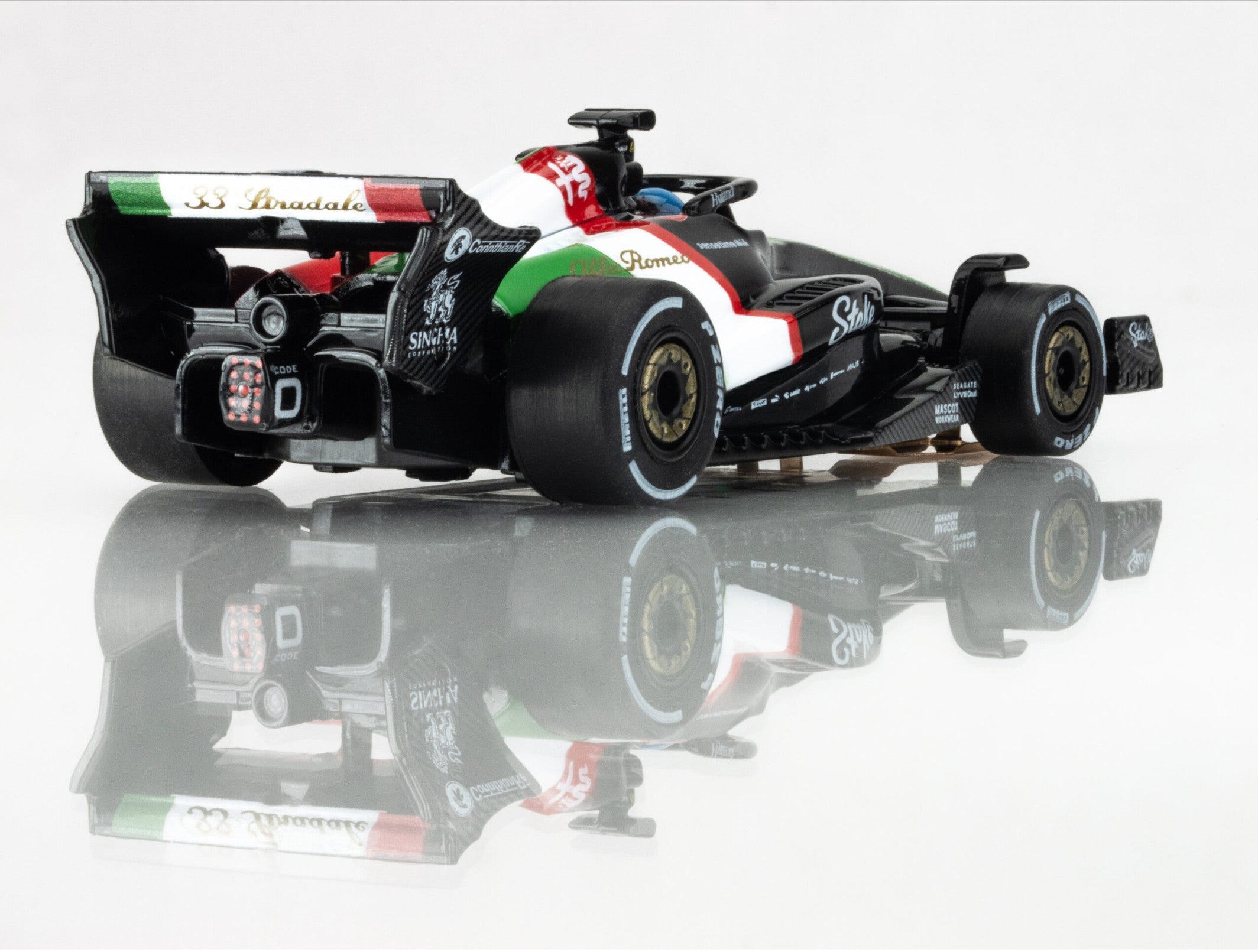 Rear-right angle view of AFX 2023 Alfa Romeo F1 Monza car showing gold wheels and aero detailing.