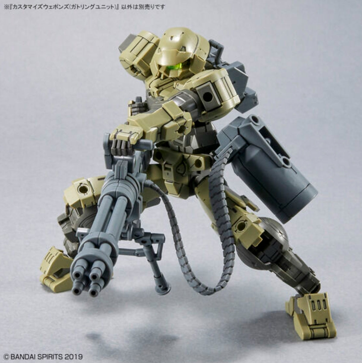 Olive green 30MM mecha crouching behind a ground-based Gatling gun setup with deployed bipod