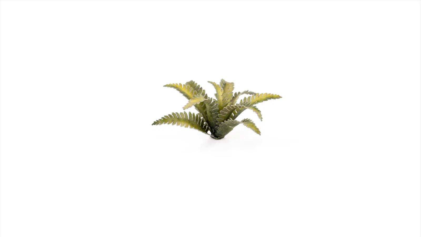 Macro detail of green and reddish-brown GamersGrass Deer Fern laser-cut plants for miniature basing