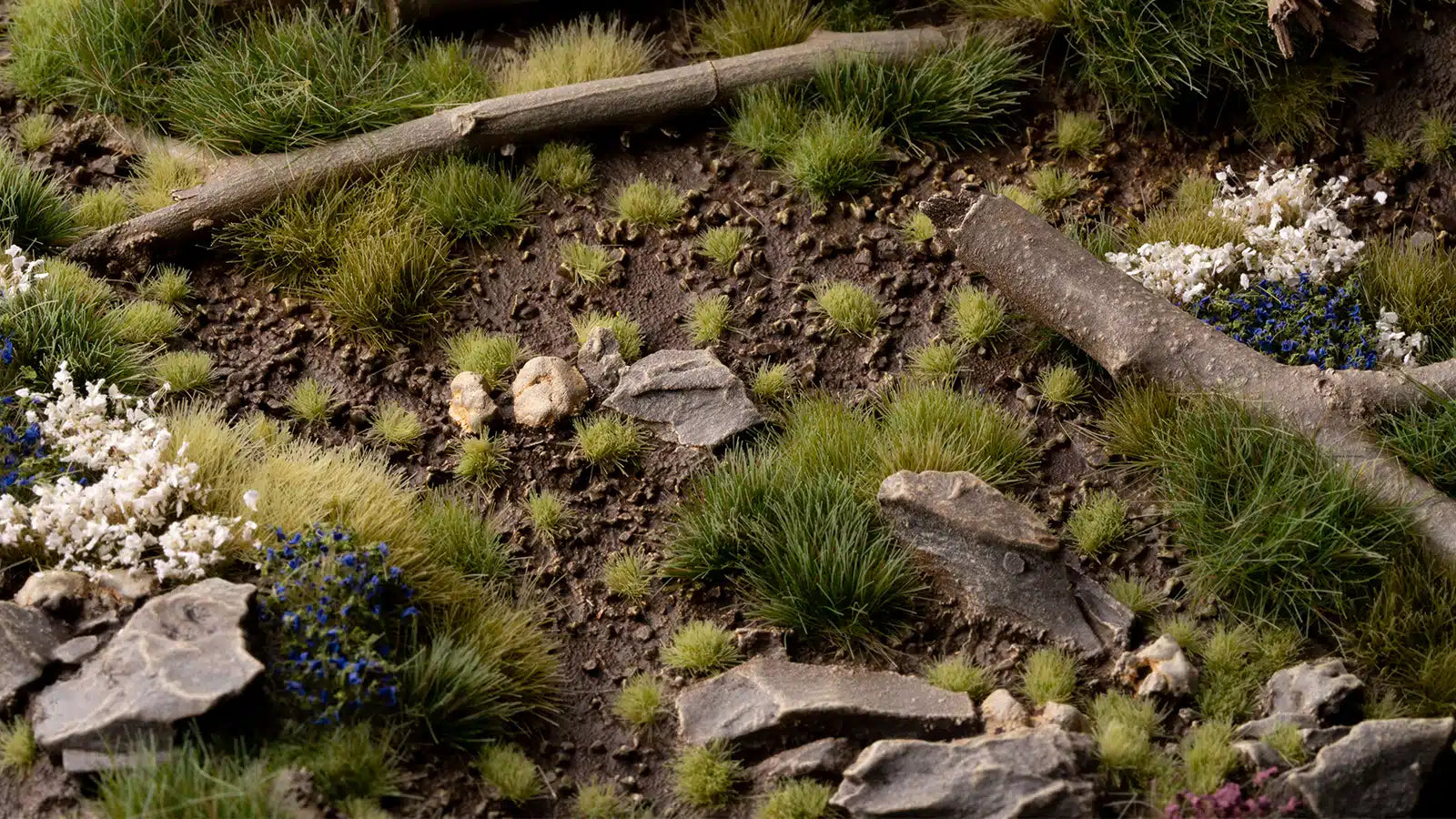 Macro diorama shot showing 2mm tiny tufts used to simulate moss and young sprouts on a 28mm base.
