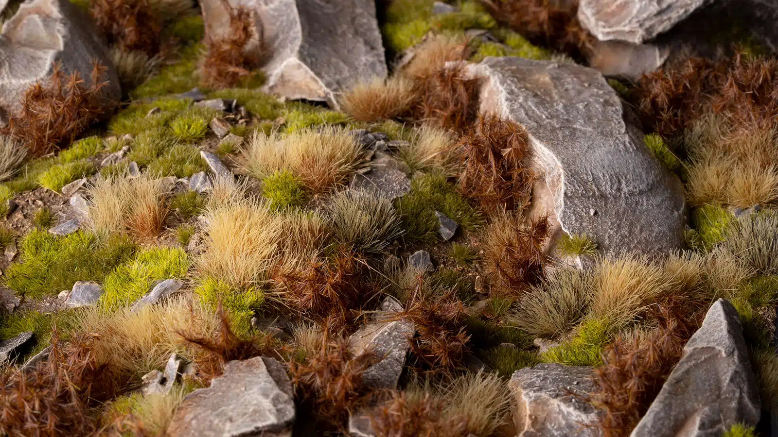 Professional diorama featuring 12mm Spikey Brown tufts used to simulate dense, dried shrubs among rocky terrain.