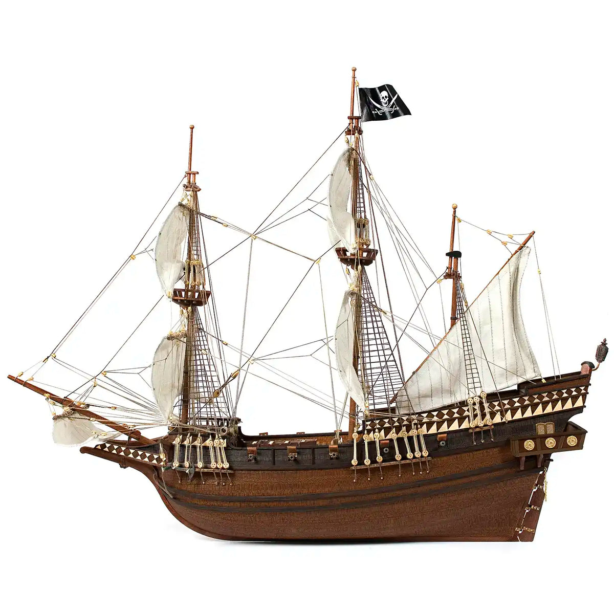 Broadside profile of the Occre 1/100 Buccaneer pirate ship showing billowing cotton sails and skull pirate ensign