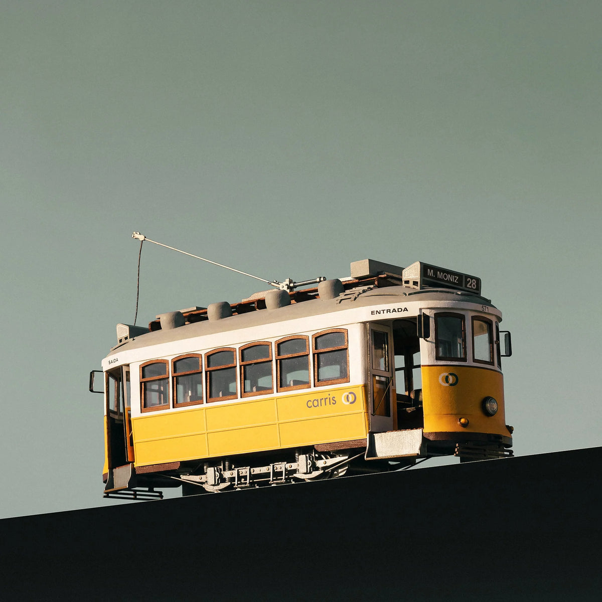 Low angle view of the completed Occre 1/24 Lisboa streetcar model highlighting wheels and cambered roof 