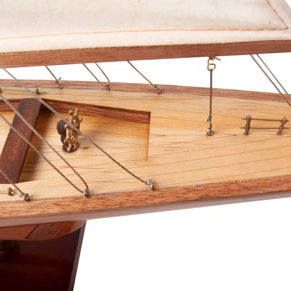 Close-up of hand-stitched linen sails and intricate rigging on Columbia model