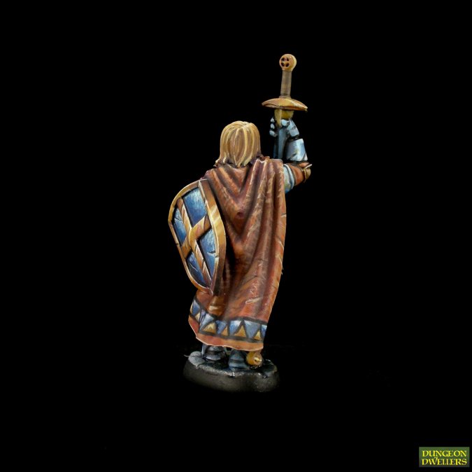 Rear view of painted Reaper Sir Danarel The Holy figure showing patterned cloak folds and sword hilt. 