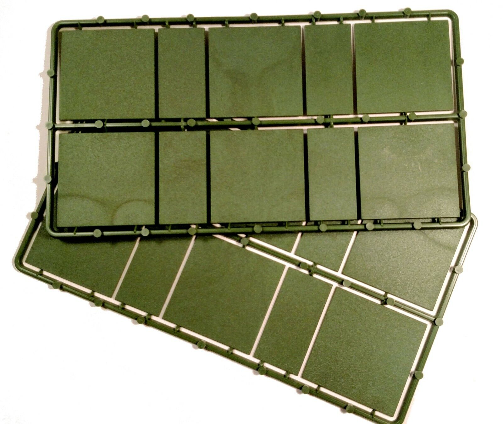 Close-up view of 50mm x 50mm and 25mm x 50mm bases with textured undersides