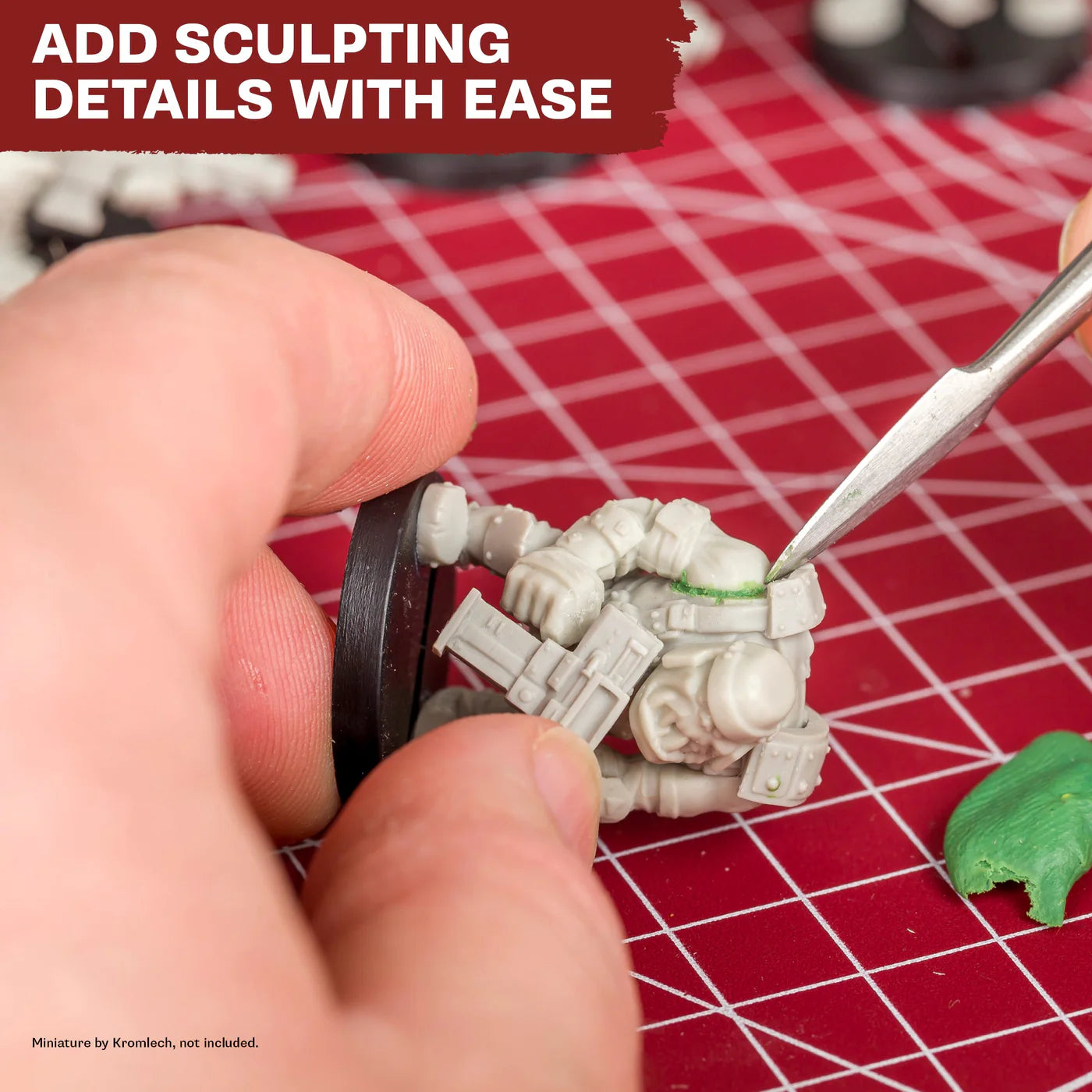 Close-up demonstration of the sculpting tool applying Green Stuff to a miniature joint for custom detail.