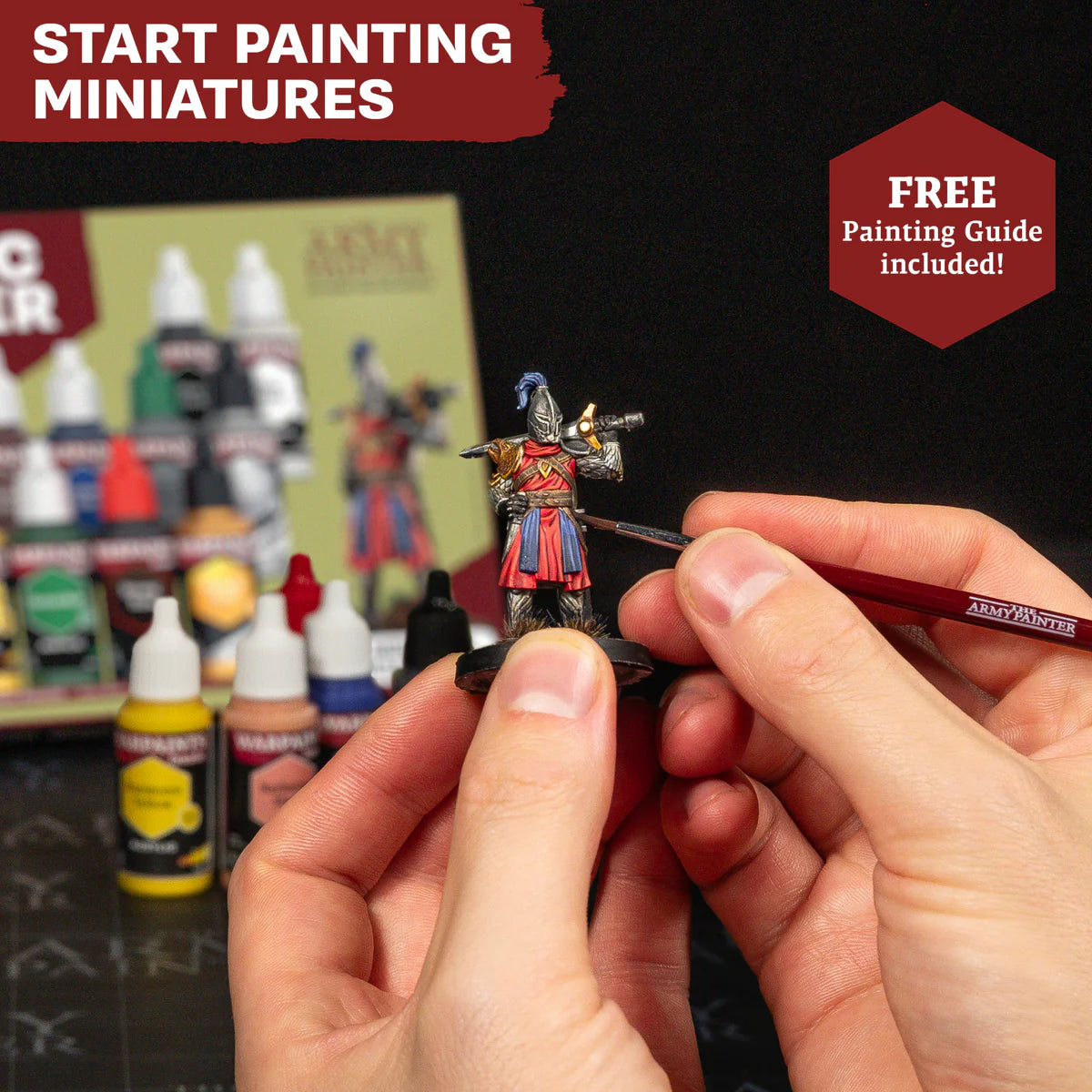 Close-up view of a hobbyist using the Starter Brush to apply detail lines onto a primed warrior miniature.