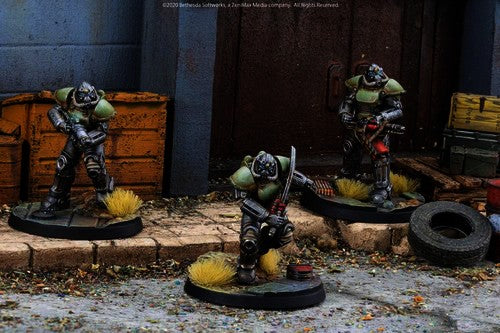 Three painted T-51 Power Armour suits deployed across an urban wasteland tabletop terrain scene