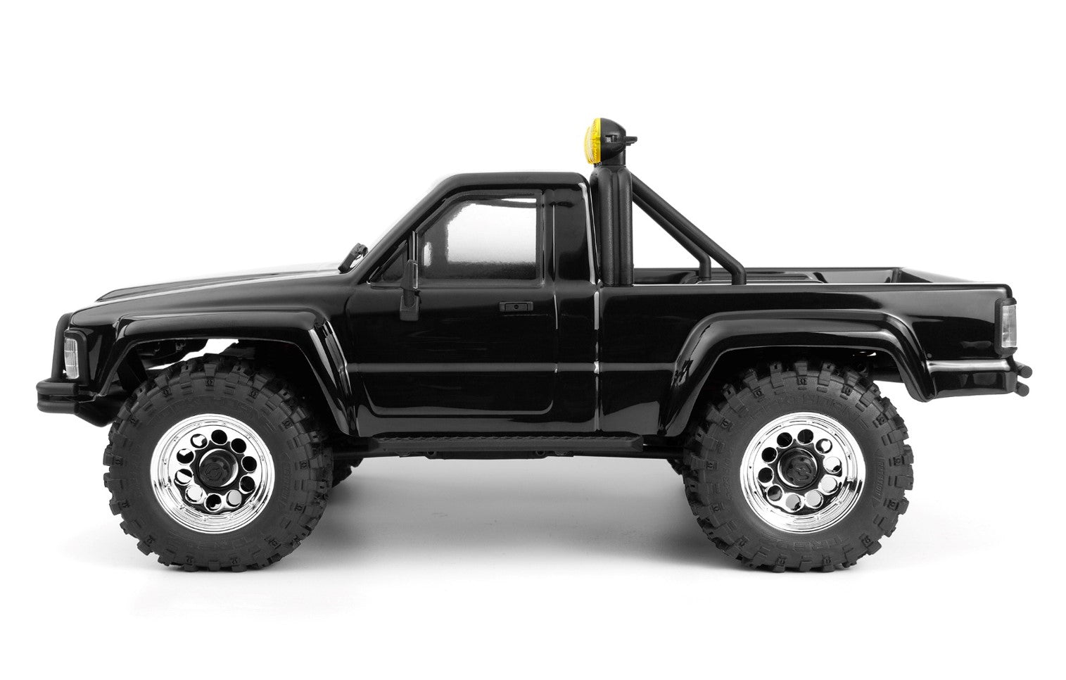 Side view of Venture18 Flux 1985 Toyota Hilux SR5 in black livery