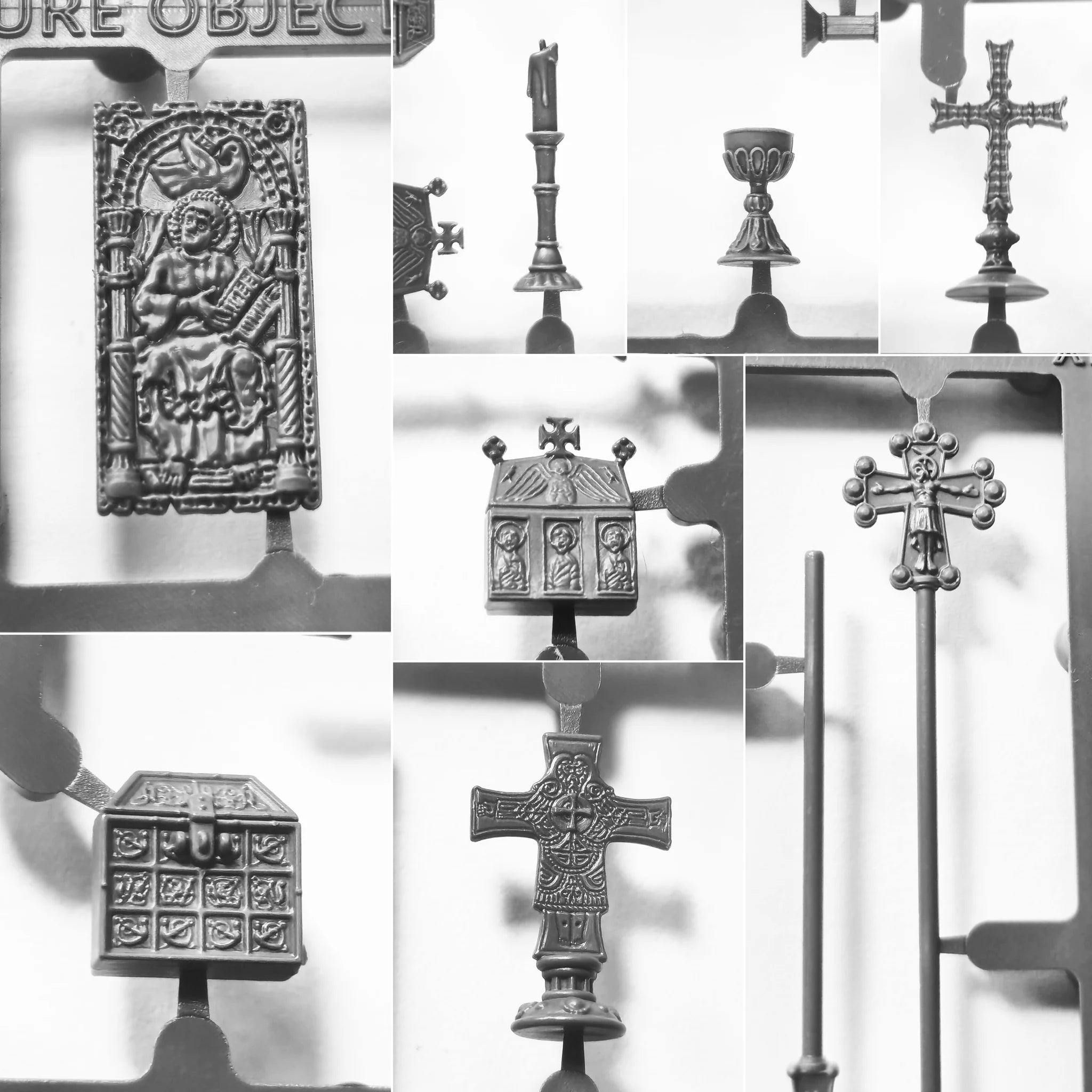 Close-up of unpainted Victrix 28mm treasures including inlaid Bible and Irish cross