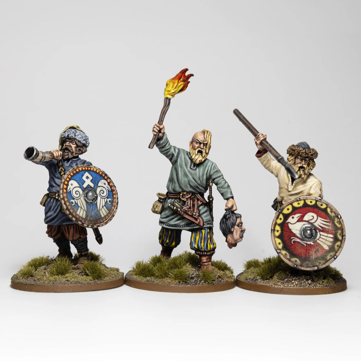Three painted Victrix 28mm Rus command figures with horn blower warrior holding torch and severed head 