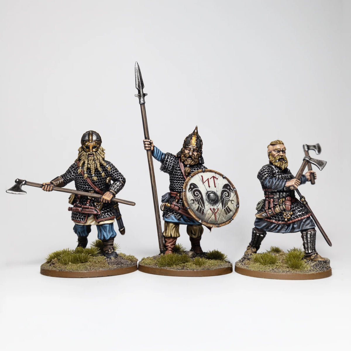 Three painted Victrix 28mm Rus warriors in chainmail wielding two-handed axe spear and hand axe 

