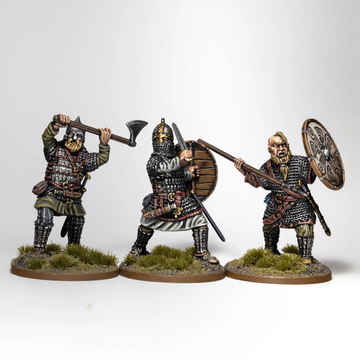 Three painted Victrix 28mm Rus infantry in lamellar armor and mail advancing with axes and spear 