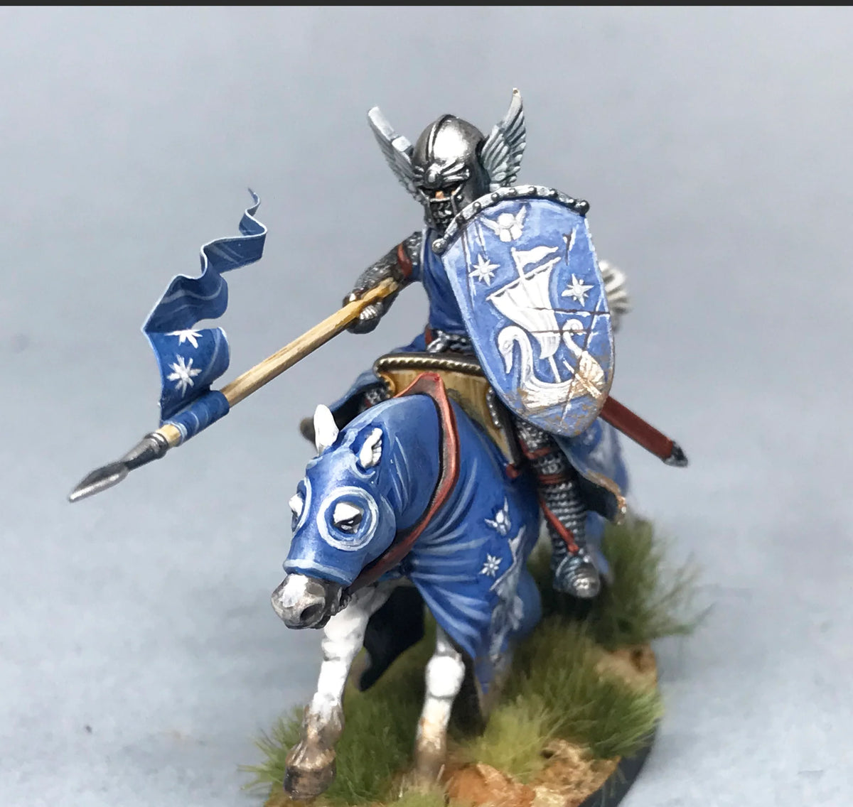 Close-up of a painted Victrix 28mm mounted knight wearing a winged barbuta helmet and swan crest shield 