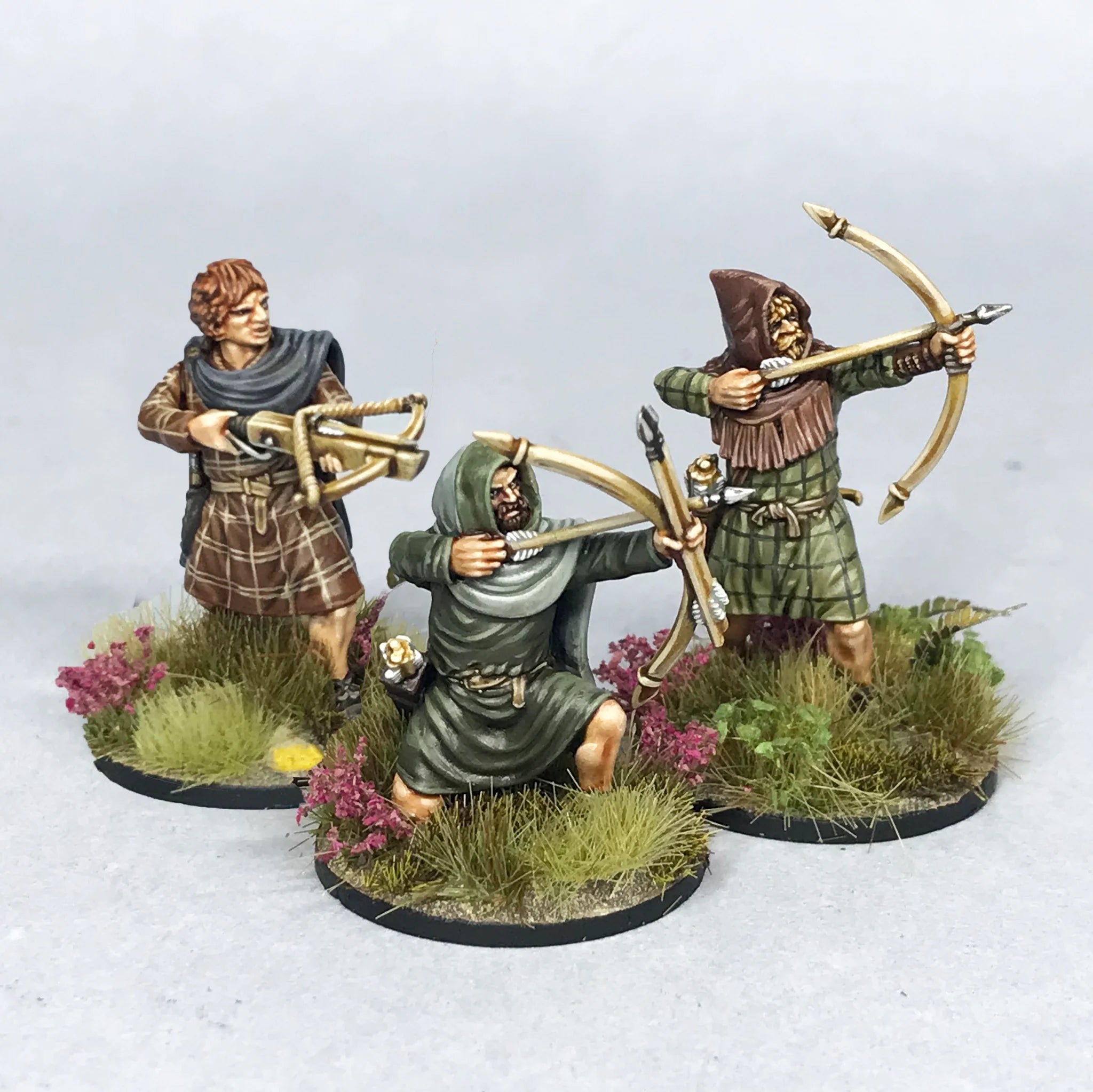 Detailed view of three painted Victrix 28mm Scots-Picts archers in dynamic shooting and loading poses