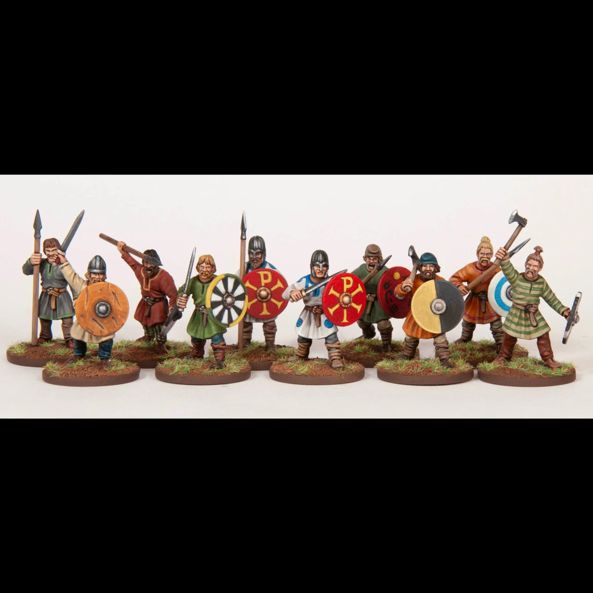Lineup of ten painted Dark Ages warrior miniatures armed with swords spears axes and shields 