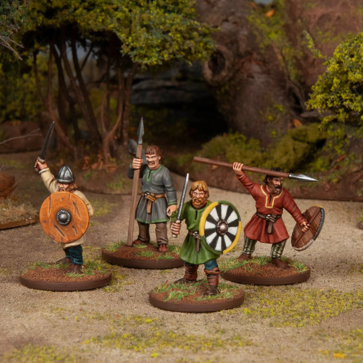 Four painted Gothic warriors skirmishing with swords spears and wooden boss shields 