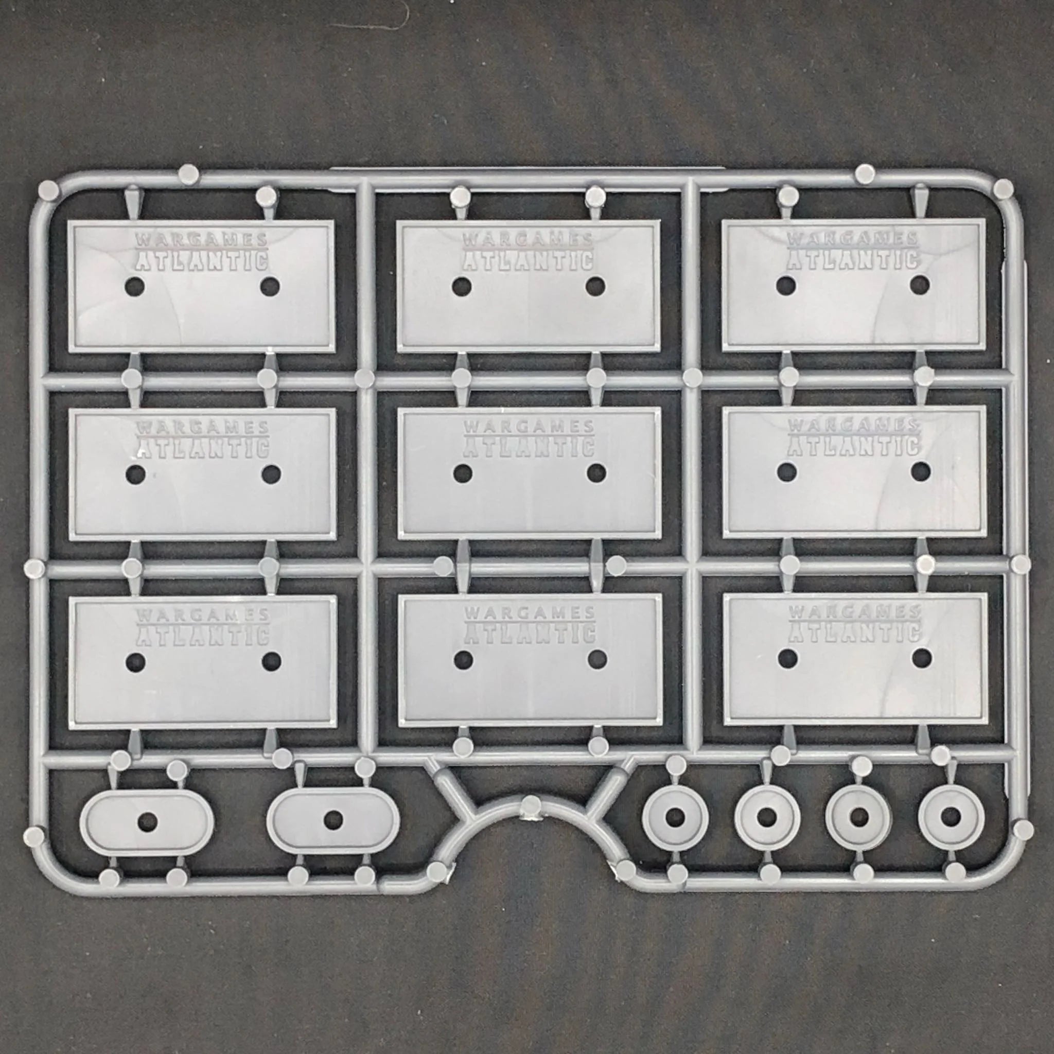 Rear view of the 40mm x 20mm plastic base sprue showcasing embedded brand labeling