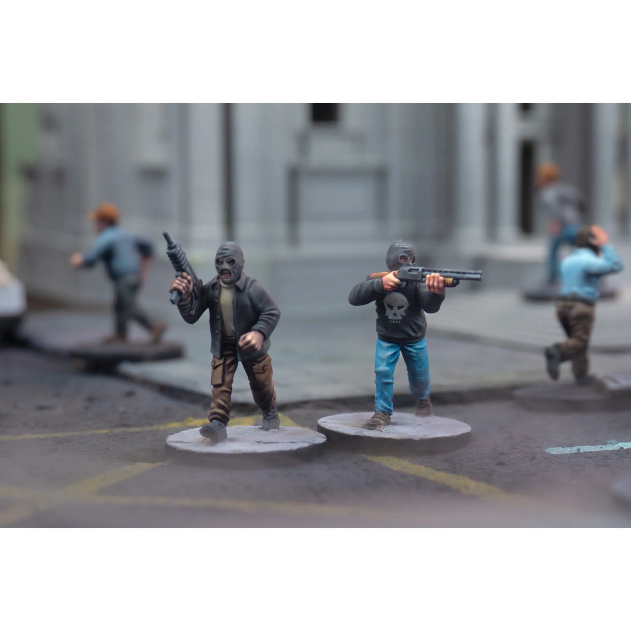 Painted miniature figures wearing balaclavas and armed with a pump shotgun and automatic pistol