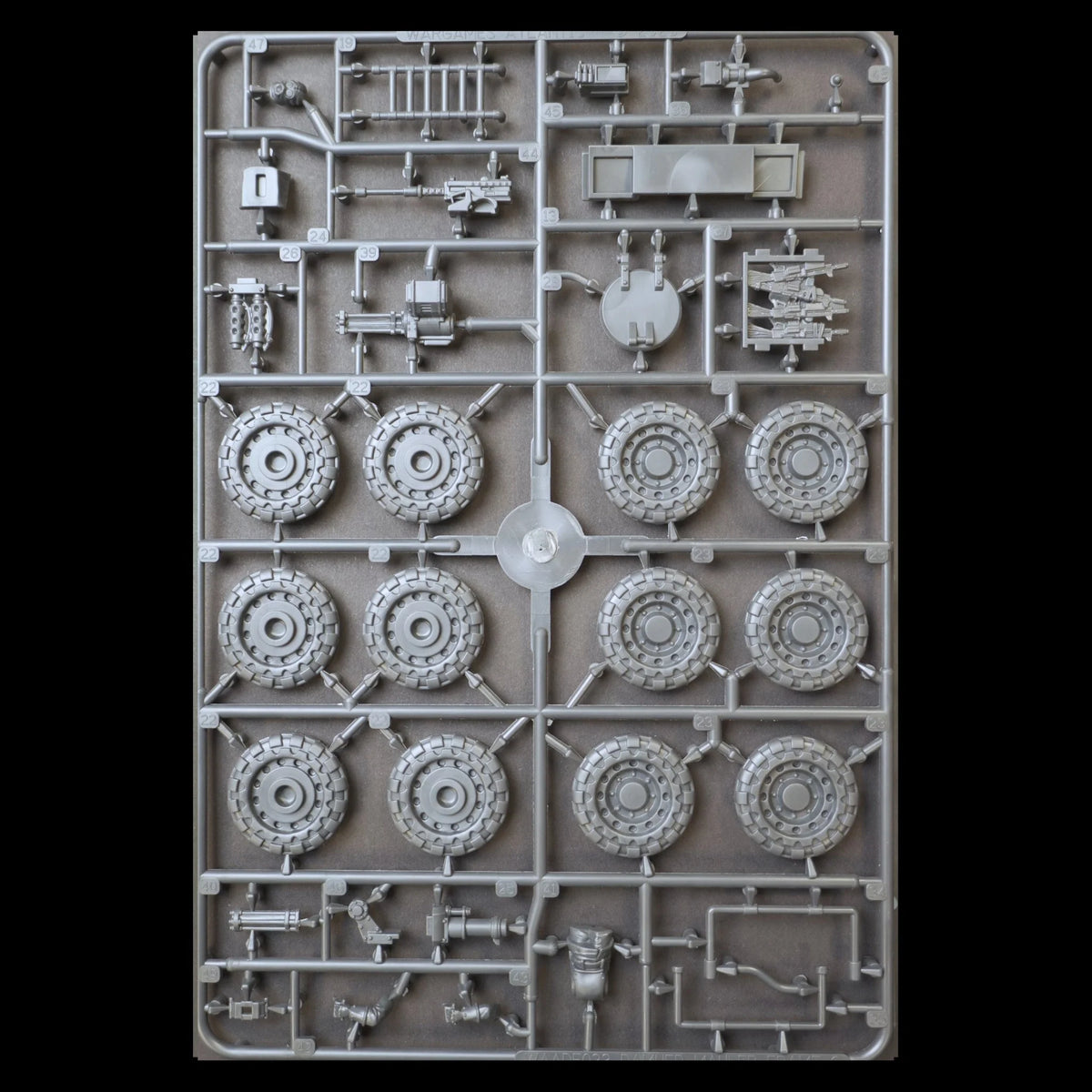 Front view of sprue frame C containing heavy wheels, weapon mounts, hatch details, and gunner crew components for The Damned Mauler