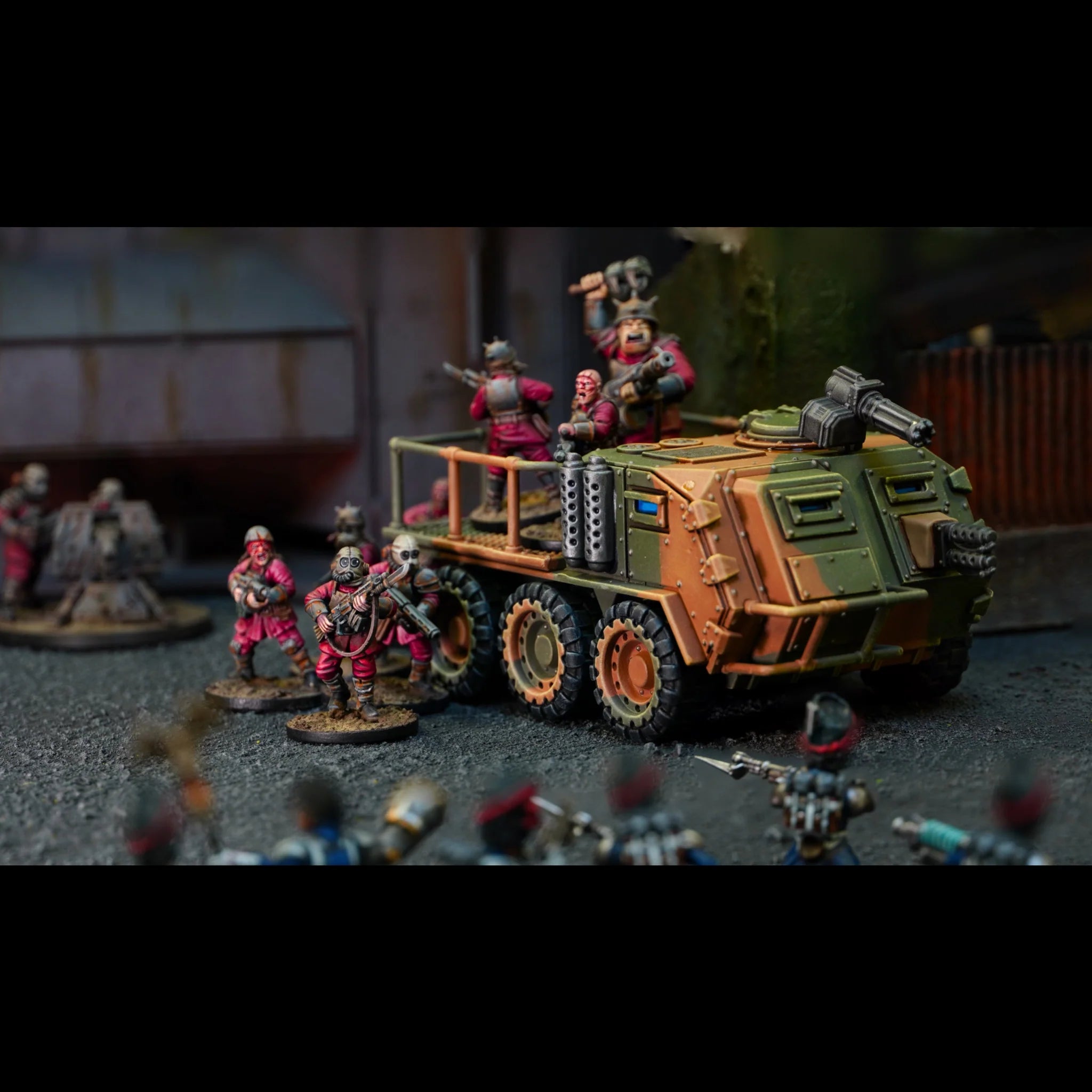 Painted flatbed Mauler transport carrying Damned infantry into battle on a warzone tabletop