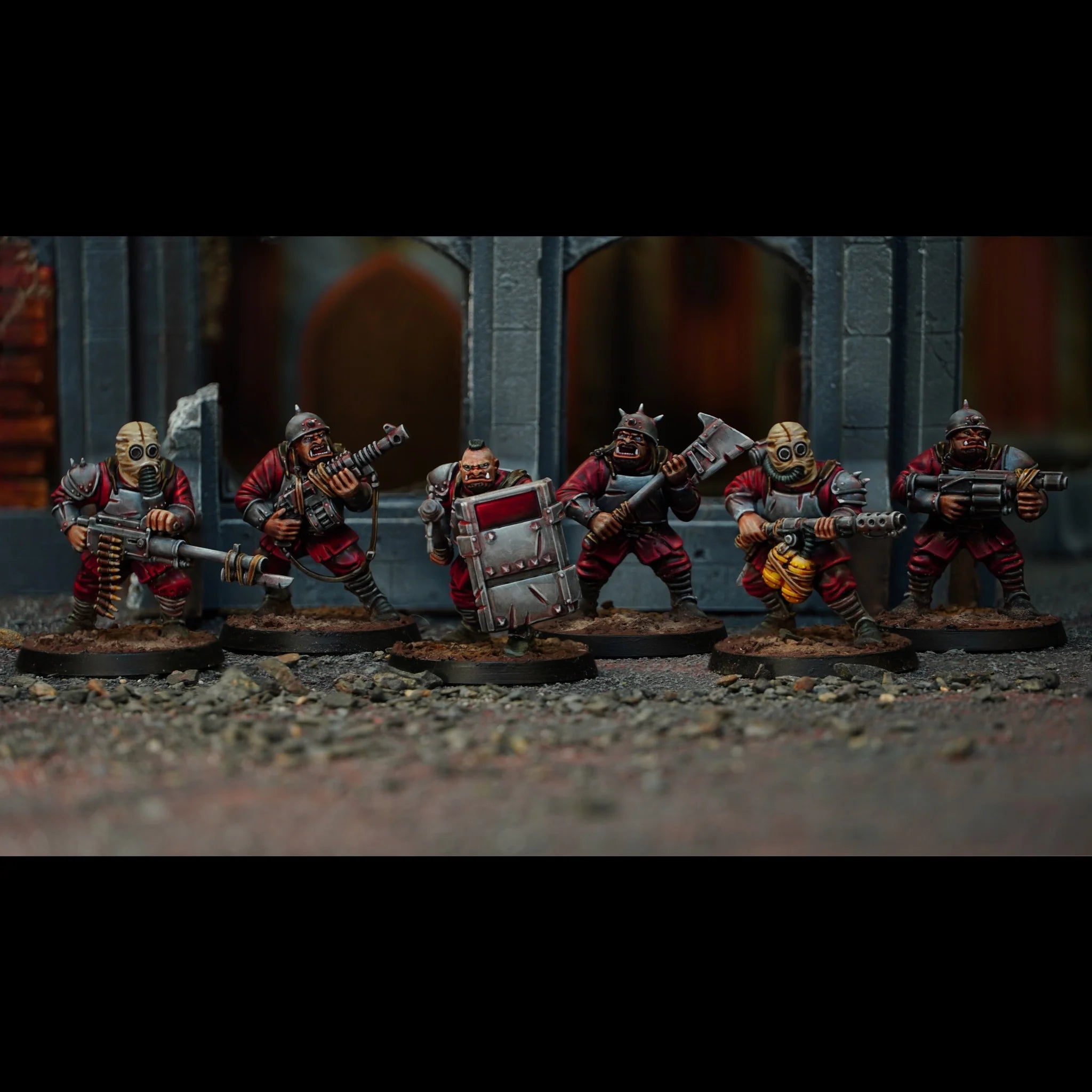 Six painted mutant Damned Brute miniatures armed with heavy machine guns, shields, and axes