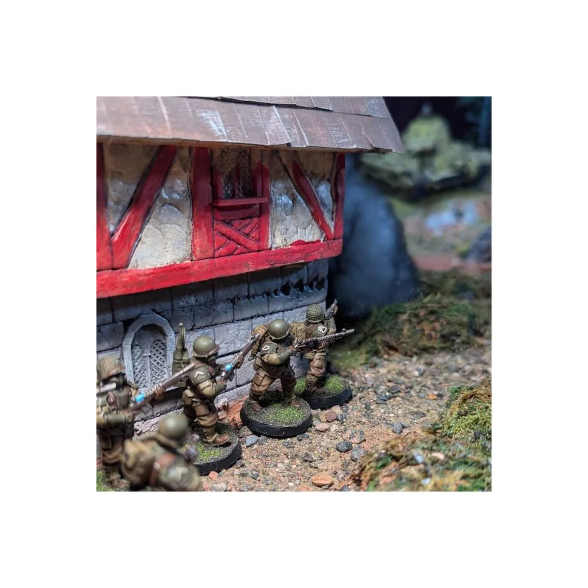 Painted United States GI infantry miniatures taking cover and clearing a building corner