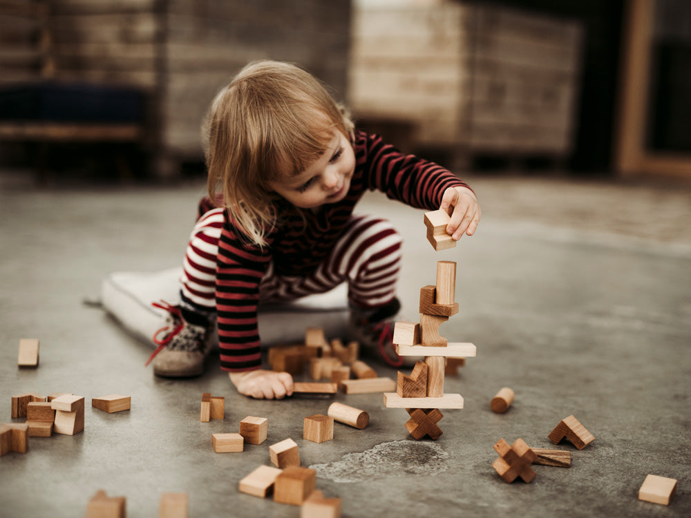 Rainbow Colored Stacking Tower Blocks At Play