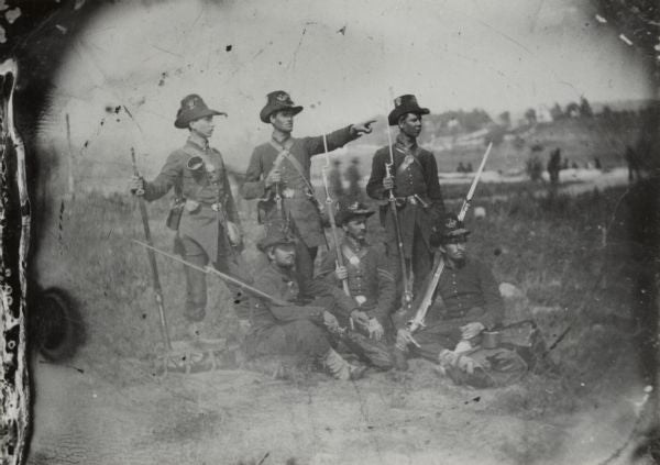 Union Army soldiers, from the 2nd Wisconsin Volunteer Infantry Regiment, Company C, of the Iron Brigade, wearing a mix of blue and gray uniforms and the distinctive hardee hats.