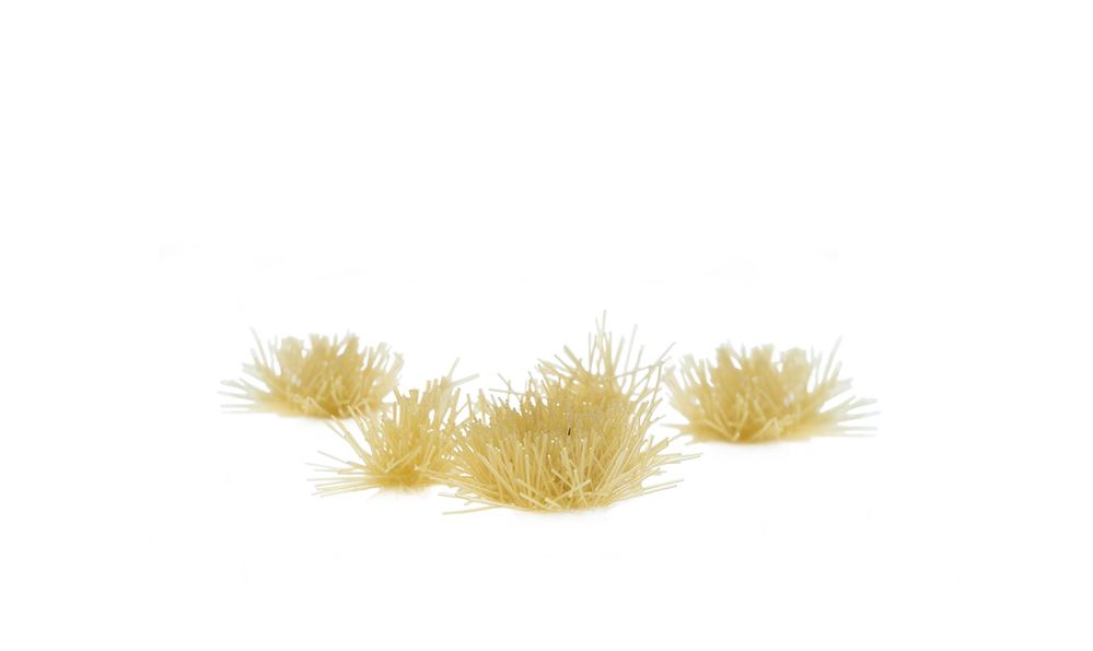 Close-up of GamersGrass Tiny Beige 2 mm tufts on a 28 mm base