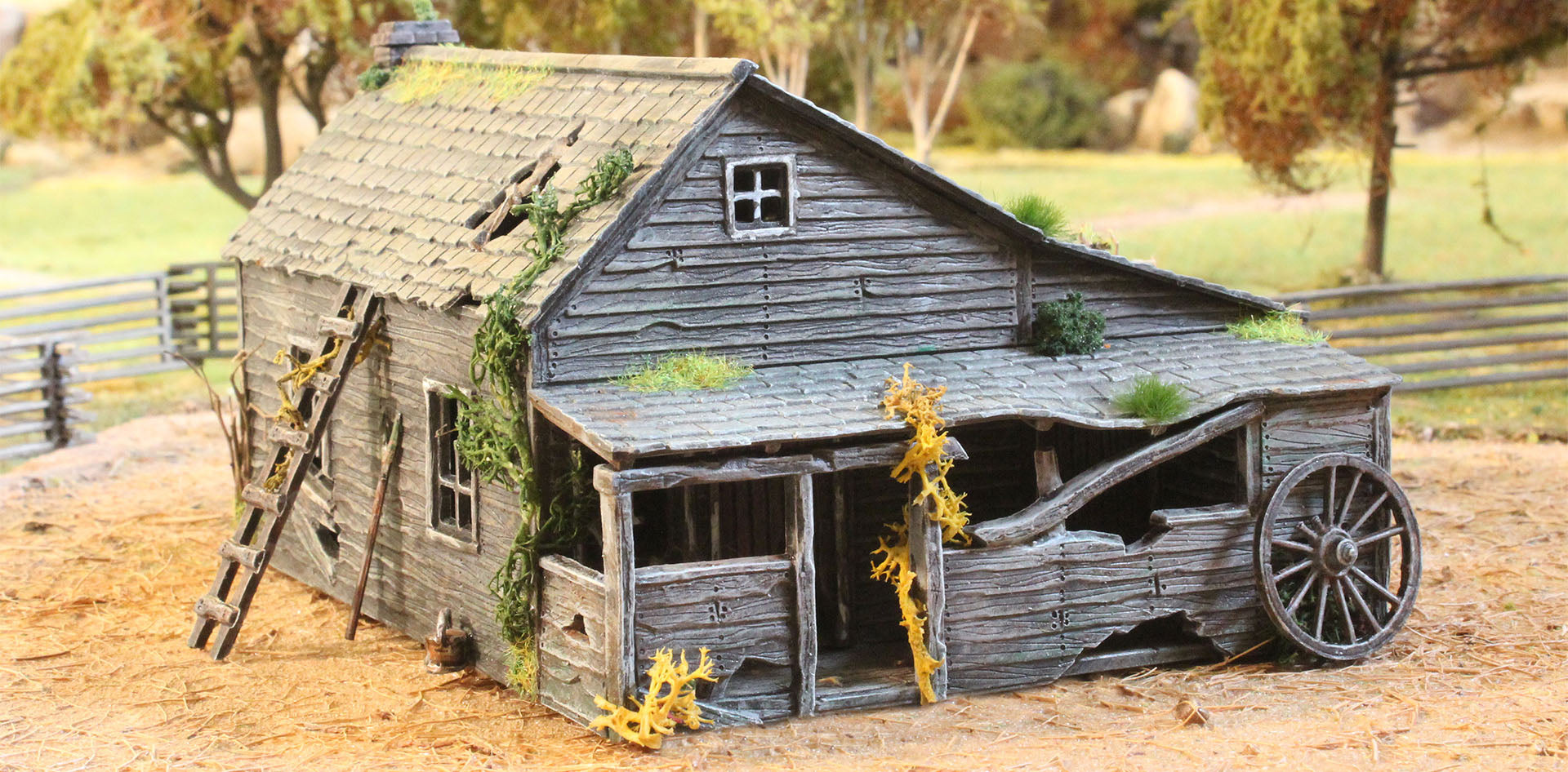 Fully assembled and painted 28mm scale Ramshackle House featuring a distressed front porch and detailed wood siding in a landscape diorama